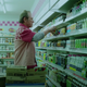 Tommy Lee Jones stacks shelves at a convenience store.